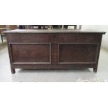 A late 19thC oak chest with a hinged lid, over a double panelled front and straight sides,