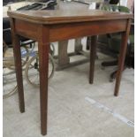 A modern Georgian style mahogany tea table, the foldover top raised on square, tapered legs,