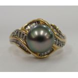 An 18ct gold black pearl and diamond ring 11