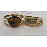 Two 9ct gold rings, one set with a tigers eye,