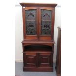 An Art Nouveau inspired mahogany cabinet, the upper section with a pair of glazed doors,