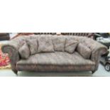 A Victorian style two person Chesterfield, part button upholstered in tones of red and pink fabric,