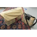 A Burberry stitched and traditionally patterned black hide handbag with original dust bag CS