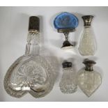 Four various 19thC cut glass scent bottles with silver mounts/caps; and a tinted blue,