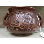 An Oriental cast and patinated bronze censer, the ogee shaped bowl having opposing loop handles,