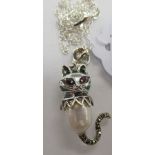 A silver coloured metal enamel, marcasite and pearl cat pendant,