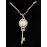 A silver coloured metal key design pendant,