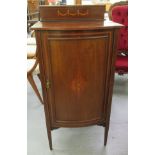 An Edwardian satinwood inlaid mahogany bow front cabinet with a single door, raised on square,