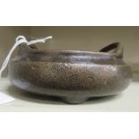 An Oriental cast and patinated bronze censer, the shallow bowl with opposing plain loop handles 4.