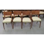 A set of four 'Ben' chairs, the teak panelled backs over cream coloured vinyl covered seats,