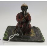 A cold painted bronze miniature figure, an Arab smoking,