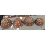 Four Victorian style copper jelly moulds of domed form,