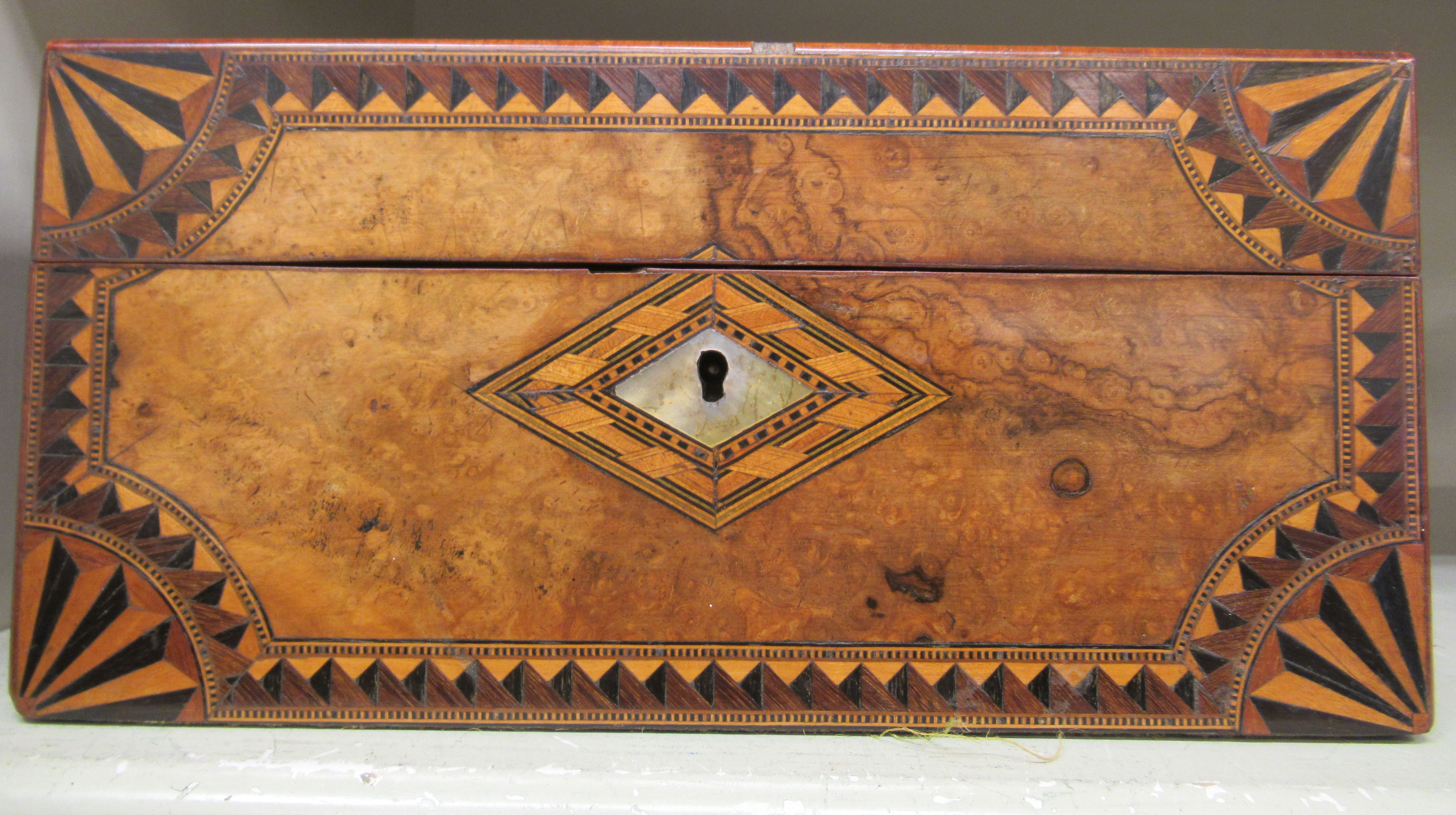 An early 19thC ebony, satinwood and burr walnut work box,