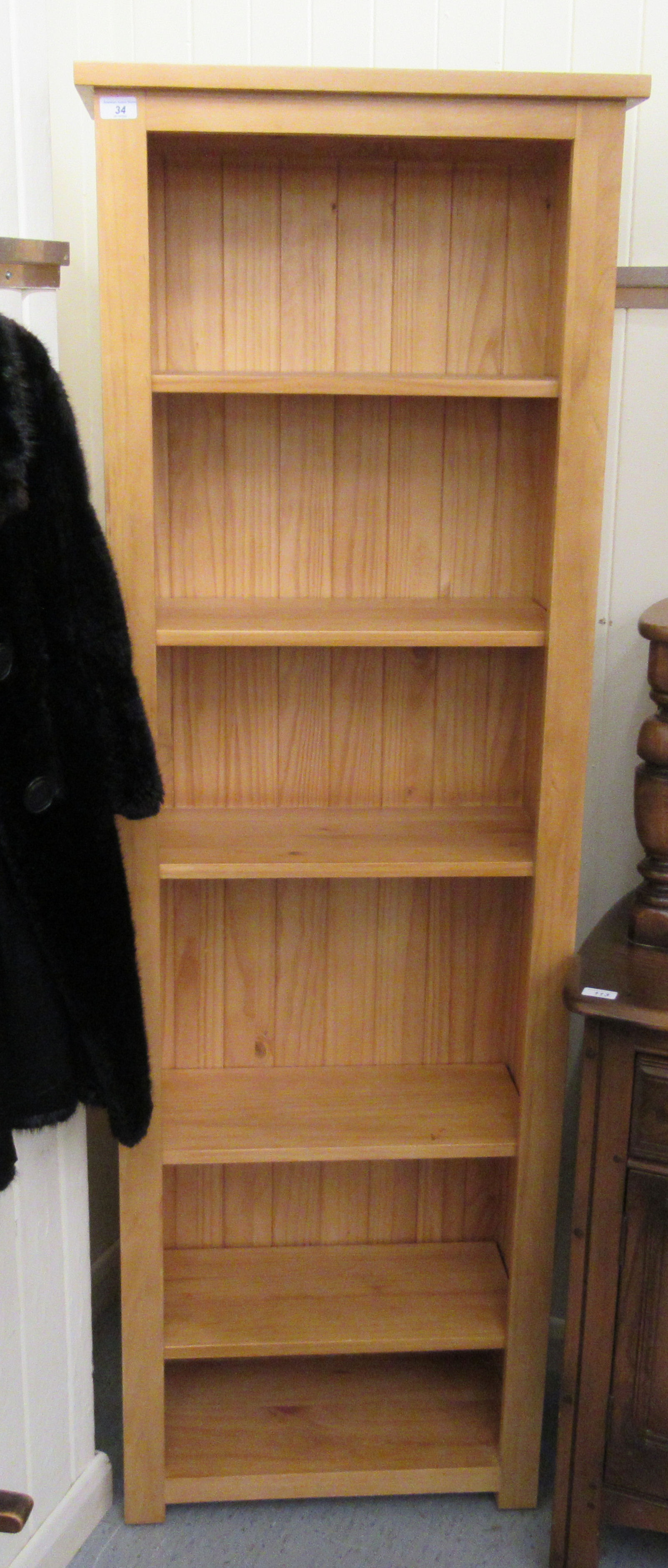 A modern Cotswold Oakley pine open front bookcase with five height adjustable shelves,