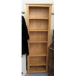 A modern Cotswold Oakley pine open front bookcase with five height adjustable shelves,