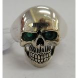 A silver coloured metal skull ring,