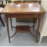 An Edwardian satinwood inlaid mahogany card table with a foldover top, raised on square,