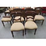 A set of six late Victorian mahogany framed, waisted spoonback dining chairs, the upholstered,