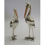 A pair of Saturno silver coloured metal and enamel models,