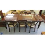 A modern reproduction of a Victorian mahogany dining table, raised on turned,