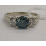 A 14ct white gold ring, the claw set central blue diamond (approx.0.