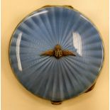 A silver circular powder compact with a hinged, radiating engine turned blue enamel lid,