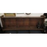 An early 20thC boarded light oak chapel pew, the canopied top acting as a lectern for those behind,