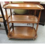 An Ercol Golden Dawn elm three tiered tea trolley,