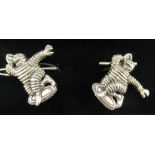A pair of silver coloured metal novelty Michelin Man cufflinks 11