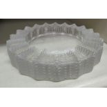 A Lalique glass ashtray, the border moulded with uniform foliate designs bears an etched mark 5.