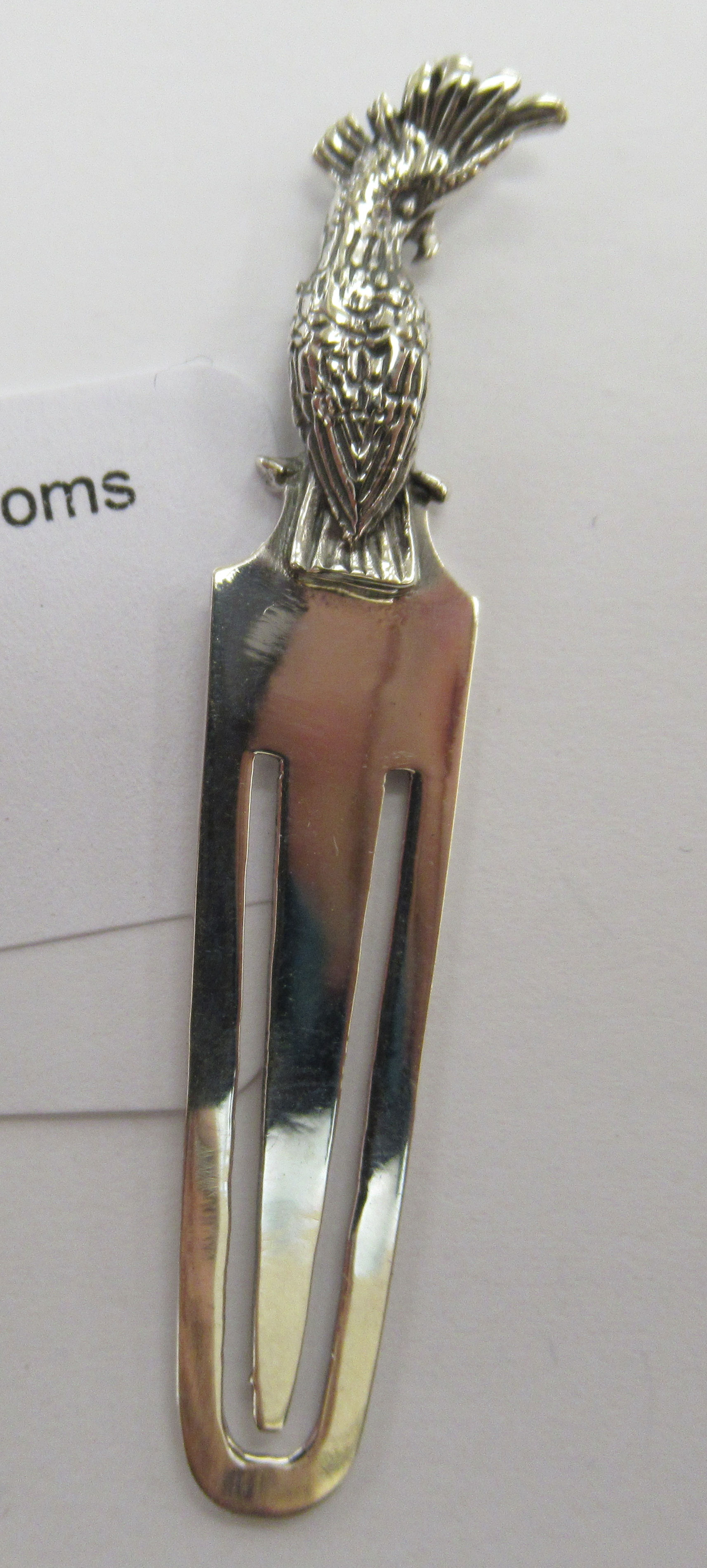 A silver coloured metal bookmark with a perched parrot finial 11