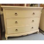 A modern white painted serpentine front dressing chest with three graduated long drawers,