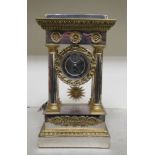 A 19thC bi-coloured metal cased, four pillar mantel timepiece, decorated with rosettes, stiff leaf,