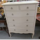 A modern white painted serpentine front dressing chest with two short/four graduated long drawers,