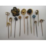 A collection of yellow metal and other stickpins: to include one set with turquoise; a pearl;