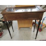 An early 20thC mahogany display table, the hinged and glazed top raised on turned,