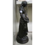 A bronze finished figure, a woman wearing Medieval costume, on a circular plinth 23.