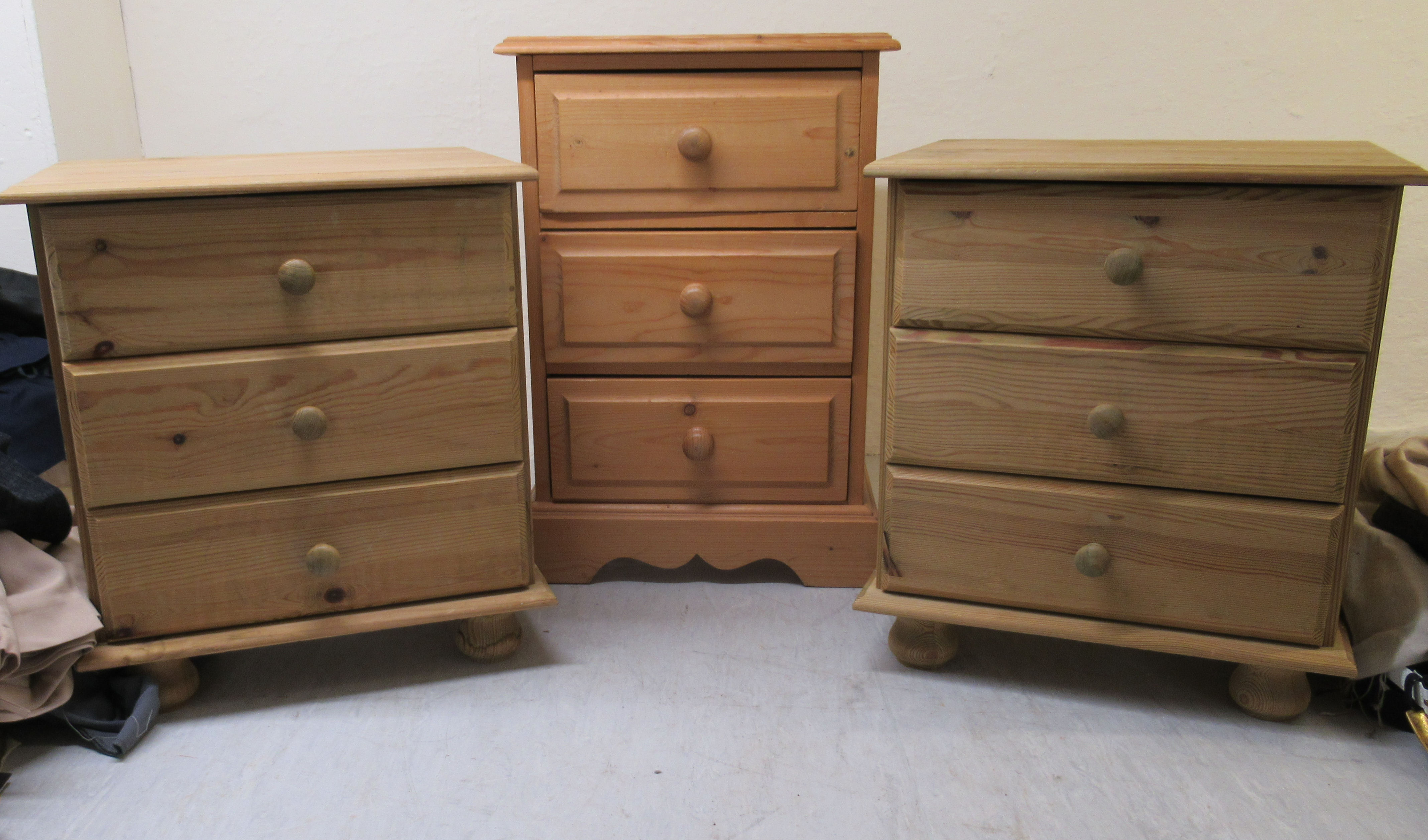 Three similar pine three drawer bedside chests, on plinths largest 23''h 15.