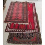 Three rugs and a Turkoman, on red grounds 36'' x 61'',