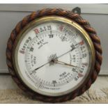 A late Victorian/Edwardian rope carved oak backed aneroid barometer,