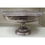 A silver fruit dish with a decoratively pierced upstand rim, elevated on a stepped,