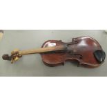 An early 20thC violin with a one piece back and inlaid purfled edge and a carved lion mask scroll,