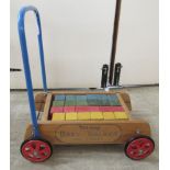 A mid 20thC Tri-ang baby walker with twenty-four coloured bricks CA