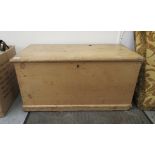 An early 20thC pine box with straight sides and a hinged lid,