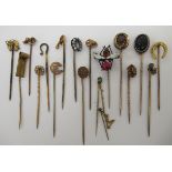 A collection of yellow metal and other stickpins: to include one fashioned as an insect;