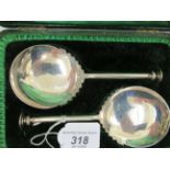 A pair of Edwardian silver presentation seal terminal serving spoons,