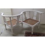 An early 20thC white painted conversation chair, having a level back and woven cane seat,
