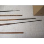 Five 20thC cast metal and turned wooden spears largest 66'' CA