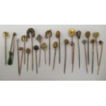 A collection of yellow metal and other stickpins, variously set with small diamonds,
