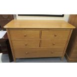An Ercol light oak dressing chest with four short drawers, over one long drawer,